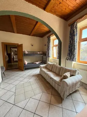 a living room with a couch in a room at Hiša 1907 in Bled
