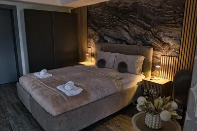 a bedroom with a large bed with towels on it at Lux room & ljubljana in Ljubljana