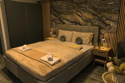 a bedroom with a bed with towels on it at Lux room & ljubljana in Ljubljana