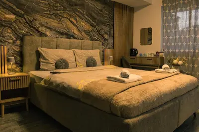 a bedroom with a large bed with towels on it at Lux room & ljubljana in Ljubljana