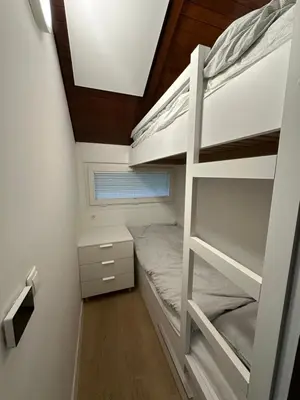 a bedroom with two bunk beds and a ceiling at Family Holiday Home in Terme Čatež in Čatež ob Savi