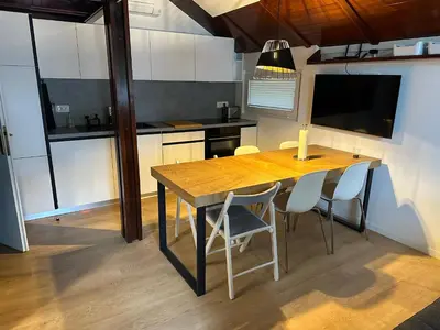 a kitchen with a wooden table and some chairs at Family Holiday Home in Terme Čatež in Čatež ob Savi
