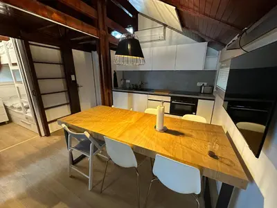 a kitchen with a wooden table and chairs at Family Holiday Home in Terme Čatež in Čatež ob Savi