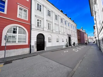 an empty city street with a white building at Modern studio apartment in the heart of old city in Ljubljana