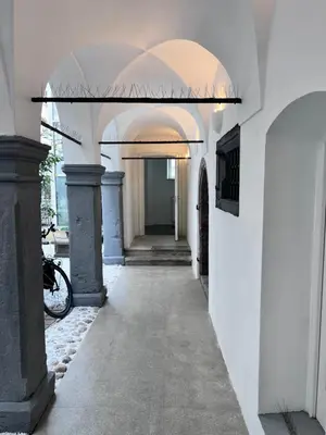 a hallway with white walls and an archway at Modern studio apartment in the heart of old city in Ljubljana