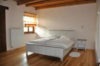 a bedroom with a white bed and a window at Pri Bregarju in Podsabotin