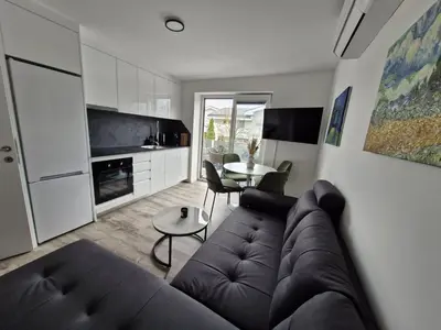 a living room with a couch and a table at Livada in Ljubljana