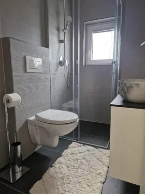 a bathroom with a toilet and a shower and a sink at Livada in Ljubljana
