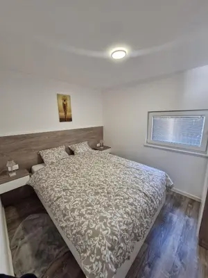 a bedroom with a bed and a window at Livada in Ljubljana