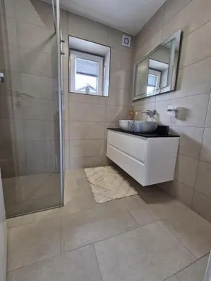 a bathroom with a sink and a shower at Livada in Ljubljana