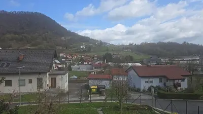 a small town with houses and a mountain at Ofta International guests house in Senovo