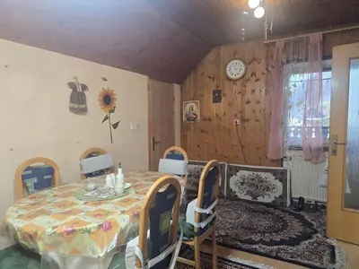 a dining room with a table and chairs in a room at Ofta International guests house in Senovo