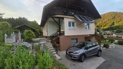 a small car parked in front of a house at Ofta International guests house in Senovo