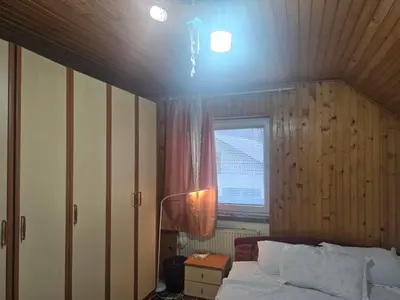 a bedroom with a bed and a window at Ofta International guests house in Senovo