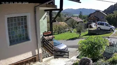 a car parked on the side of a house at Ofta International guests house in Senovo
