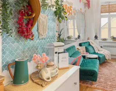 a living room with a green couch and a table at Casa1895, Stylish Old Town Apartment near Beer Fountain in Žalec