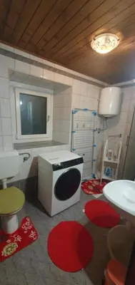 a bathroom with a sink and a tv on the wall at Sigma house in Mojstrana