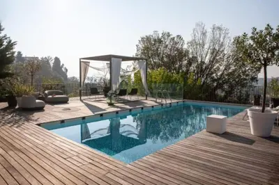 a swimming pool with a wooden deck and a wooden deck at Peaceful Stay Among the Vines in Vipolže