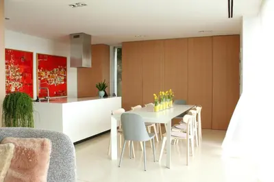 a kitchen and dining room with a white table and chairs at Peaceful Stay Among the Vines in Vipolže