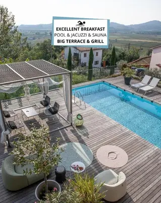 a swimming pool with a wooden deck and a sign at Peaceful Stay Among the Vines in Vipolže