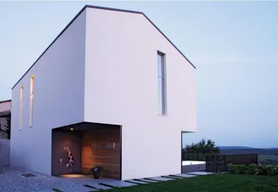 a white house with a black door at Peaceful Stay Among the Vines in Vipolže