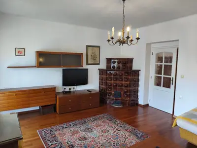 a living room with a flat screen tv and wooden furniture at Villa Pinta Pika in Ljubljana