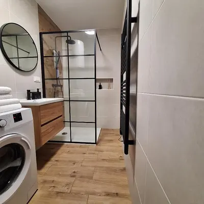 a bathroom with a washing machine and a sink at Apartment GA-JA in Ljubljana
