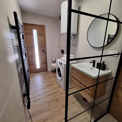 a bathroom with a sink and a washing machine at Apartment GA-JA in Ljubljana