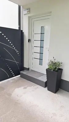 a front door of a house with two plants on it at Apartment GA-JA in Ljubljana