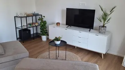 a living room with a tv on a white dresser at Apartment GA-JA in Ljubljana