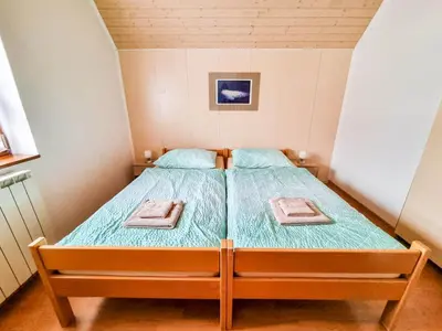 a bedroom with a bed with two towels on it at Apartma Jakob 2 in Bovec