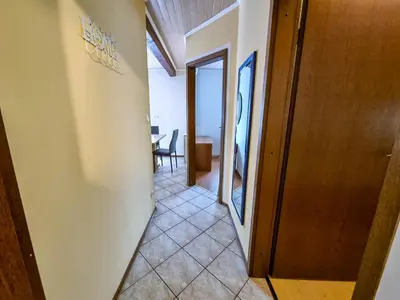 a hallway leading to a room with a table at Apartma Jakob 2 in Bovec
