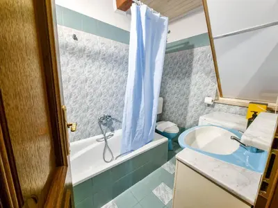 a bathroom with a tub and a sink and a toilet at Apartma Jakob 2 in Bovec