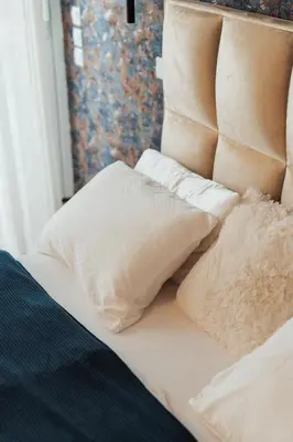 a bed with white pillows on top of it at Apartma Tyrseva in Maribor