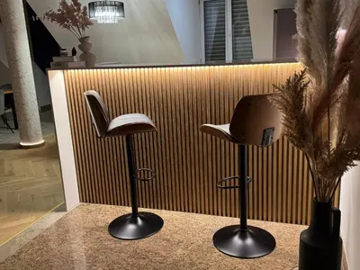 two stools in front of a corrugated wall at Apartma Tyrseva in Maribor