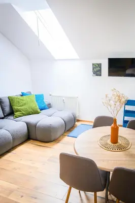 a living room with a table and a couch at The Cosy Loft in Ljubljana
