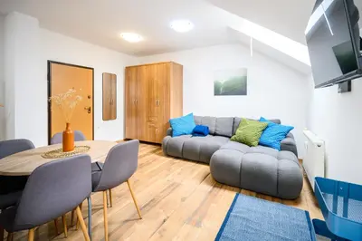 a living room with a couch and a table at The Cosy Loft in Ljubljana