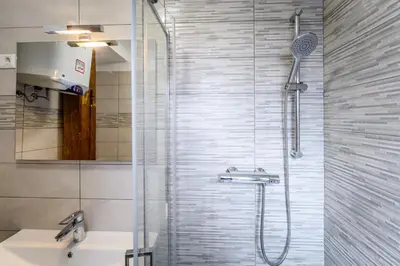 a bathroom with a shower and a sink at The Cosy Loft in Ljubljana