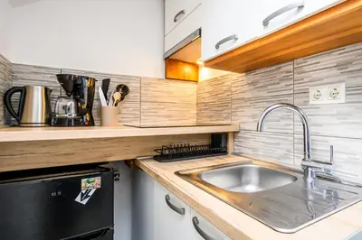 a kitchen with a sink and a counter top at The Cosy Loft in Ljubljana