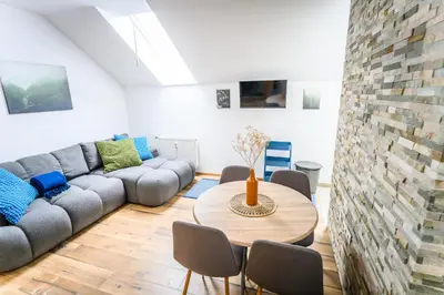 a living room with a couch and a table at The Cosy Loft in Ljubljana