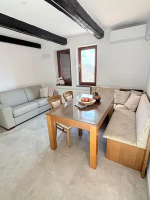 a living room with a table and a couch at Holiday house David in Podčetrtek