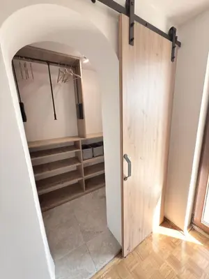 a door leading into a dressing room with a mirror at Holiday house David in Podčetrtek