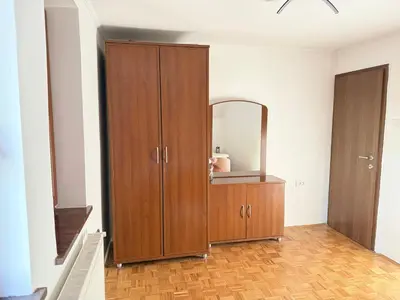 a room with a wooden cabinet with a mirror at Holiday house David in Podčetrtek