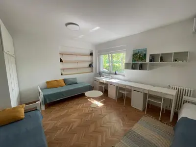 a living room with a couch and a table in it at At the Burkulis' in Ljubljana