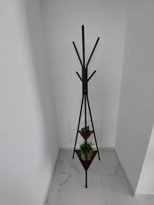a black pole in a room with a plant at Apartma 47 in Kobarid