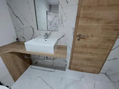 a bathroom with a sink and a mirror at Apartma 47 in Kobarid