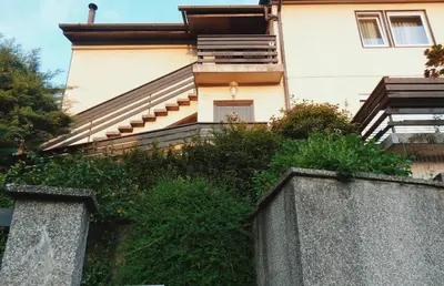 a building with stairs and plants in front of it at Peaceful Heartwarming Home With A Green Terrace in Maribor