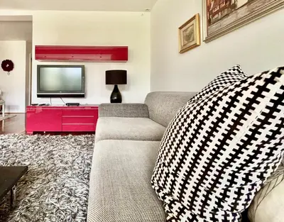 a living room with a couch and a tv at Peaceful Heartwarming Home With A Green Terrace in Maribor