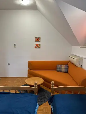 a living room with a couch and a table at Mirni kotiček in Čatež ob Savi