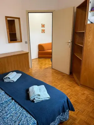 a room with a bed with towels on it at Mirni kotiček in Čatež ob Savi